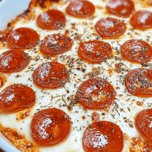 Sliced pepperoni pizza with melted cheese and herbs, close-up view.