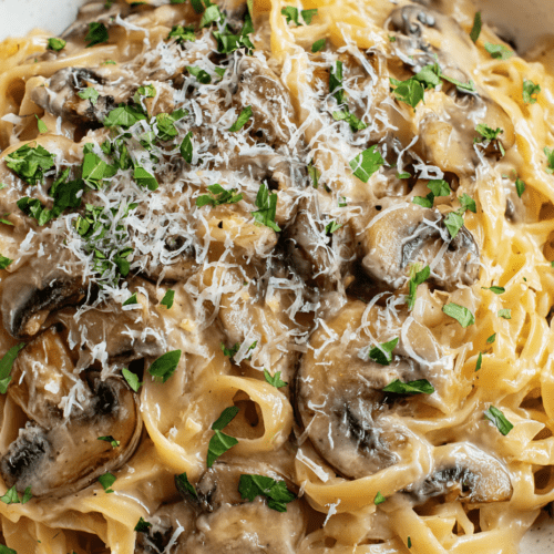 Creamy mushroom fettuccine pasta with fresh herbs and grated cheese. Perfect for a comforting Italian dinner.