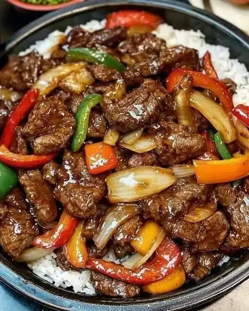 Sizzling Chinese pepper steak with onions served on a plate