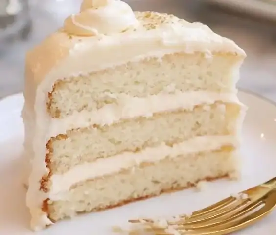 Elegant white almond wedding cake with intricate decorations for a perfect celebration