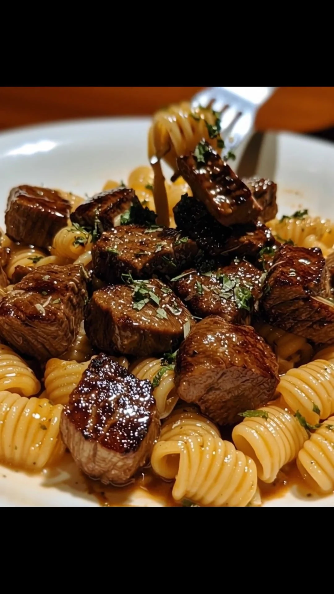 Delicious Garlic Butter Steak Bites served with creamy Parmesan pasta.