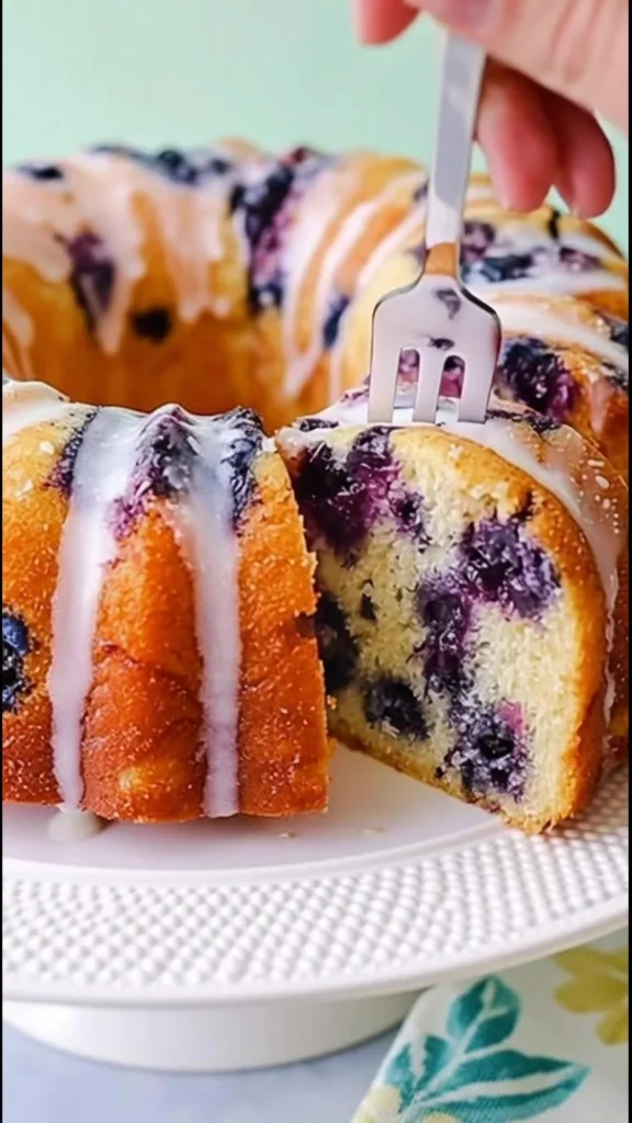 Delicious homemade blueberry cake topped with fresh blueberries