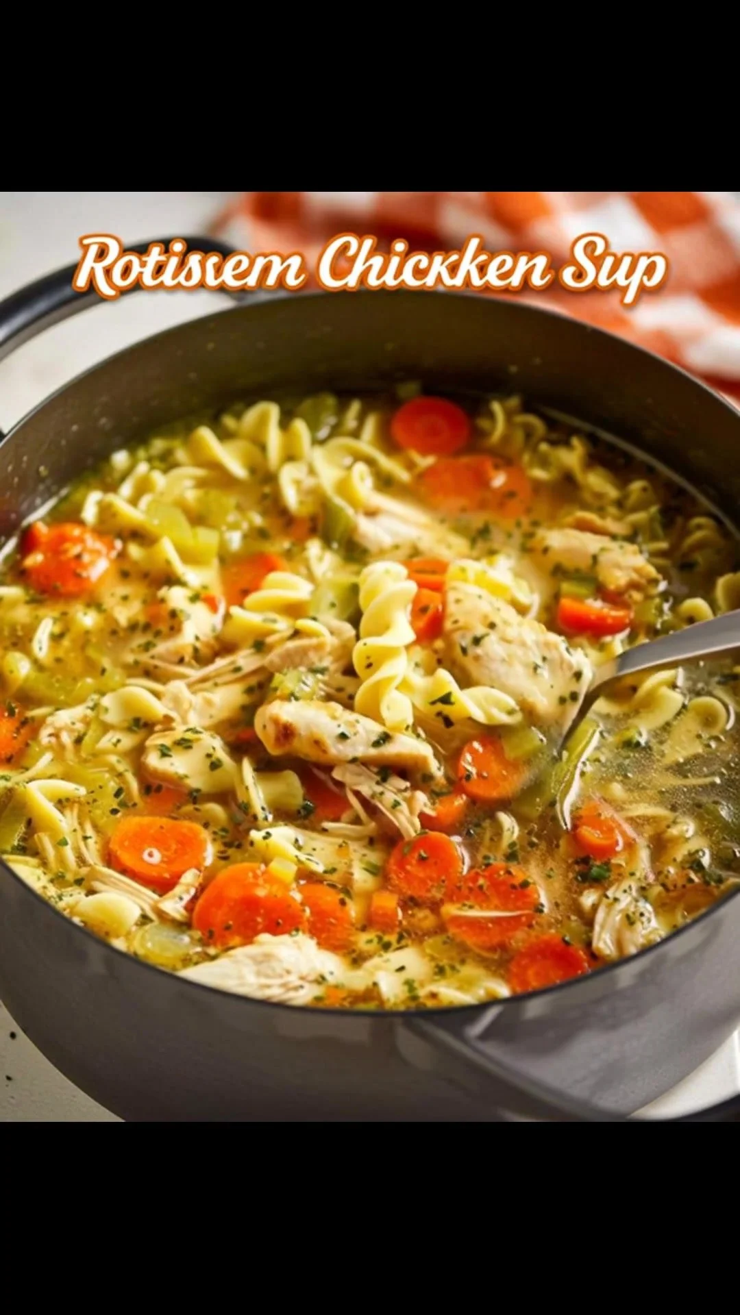 Bowl of homemade Rotisserie Chicken Noodle Soup with fresh vegetables and noodles