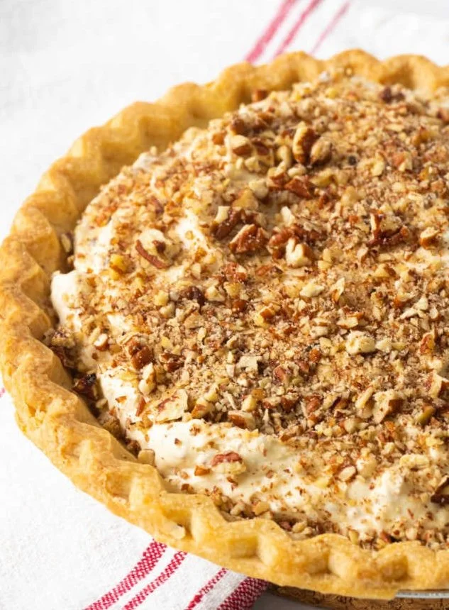 A variety of delicious Thanksgiving desserts on a festive table.