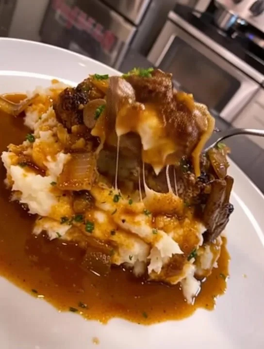 Salisbury steak served with garlic mashed potatoes and mushroom onion gravy