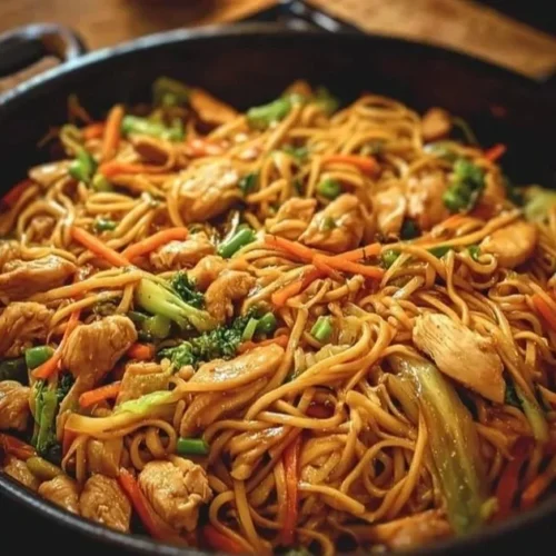 A plate of Chicken Lo Mein with colorful vegetables and tender chicken