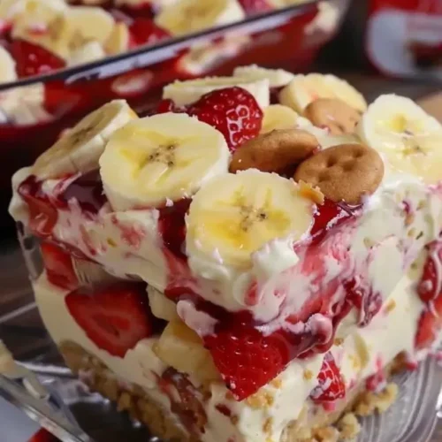 Delicious strawberry banana pudding served in a bowl, topped with fresh strawberries.